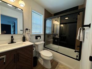 a bathroom with a toilet and a shower and a sink at Dream! in Newark +37 photos