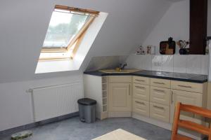 a small kitchen with a sink and a window at Ferienwohnung Prenzlau in Prenzlau