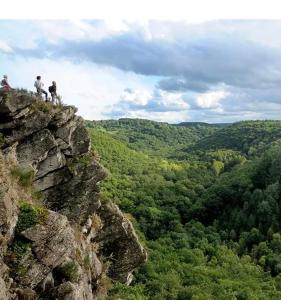 two people standing on top of a rocky mountain at Appartement cosy en plein centre ville in Saint-Pierre-du-Regard