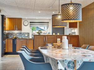 a dining room with a table and chairs at Holiday Home Fidelia - 400m from the sea by Interhome in Storvorde