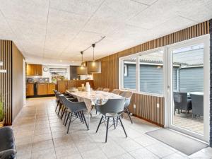 an open kitchen and dining room with a table and chairs at Holiday Home Fidelia - 400m from the sea by Interhome in Storvorde +17 photos