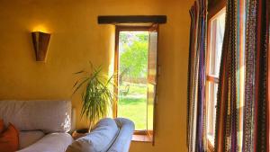 a living room with a couch and a window at Cortijo El Potro in Órgiva +52 photos