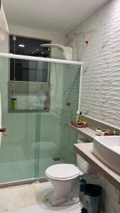 a bathroom with a shower and a toilet and a sink at Casa para temporada Balneário de IRIRI Espírito Santo ES in Iriri
