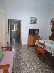 a living room with a table and a tv at Casa Teresina in Cannole