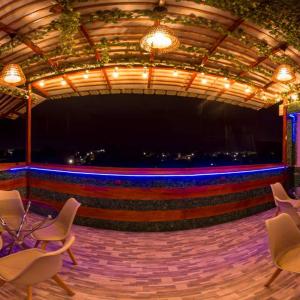 a stage with chairs and a stage with blue lights at Sonqu Tarapoto in Tarapoto