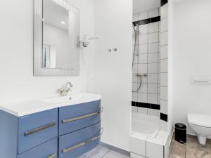 a bathroom with a blue sink and a shower at Holiday Home Aliza - 14km from the sea by Interhome in Bredebro +28 photos