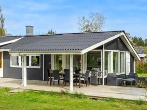 a pavilion with a table and chairs on a deck at Holiday Home Alkil - 350m to the fjord by Interhome in Storvorde