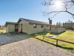a house with a fence in front of it at Holiday Home Frille - 200m from the sea by Interhome in Blåvand