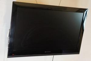 a flat screen tv sitting on a wall at Lila Casas de Montaña in La Cumbrecita