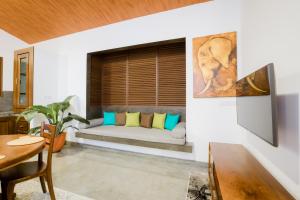 a living room with a couch and a table at 701 Mawella Villa in Mawella