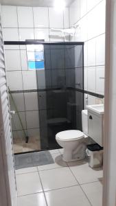 a bathroom with a toilet and a sink at CASA TEMPORADA PERUIBE in Peruíbe