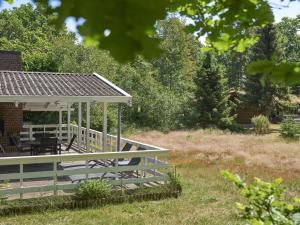 a deck with a gazebo in a yard at Holiday Home Gjertrud - 1km from the sea by Interhome in Rønne