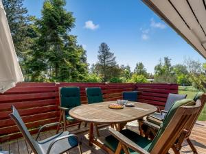 a patio with a wooden table and chairs at Holiday Home Borghild - 500m from the sea by Interhome in Gedser