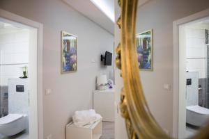 a bathroom with two toilets and a mirror at Boutique Hotel Melissa in Poreč