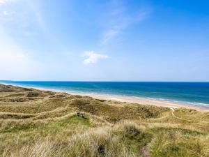 an empty beach with the ocean in the background at Holiday Home Aster - 150m from the sea by Interhome in Hirtshals