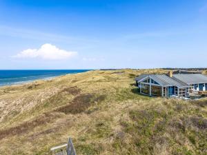 a house on a hill next to the ocean at Holiday Home Aster - 150m from the sea by Interhome in Hirtshals
