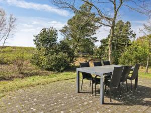 a table and chairs sitting on a patio at Holiday Home Alina - 1km from the sea by Interhome in Mølby