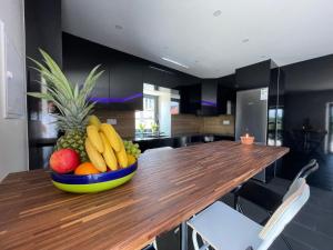 a bowl of fruit on a wooden table in a kitchen at Living Viana do Castelo in Viana do Castelo