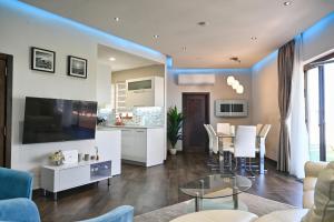 a living room with a kitchen and a dining room at Gozo Luxury Penthouse in Qala
