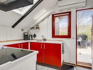 Una cocina con gabinetes rojos y blancos y una ventana. en Holiday Home Magnus - 250m to the fjord by Interhome, en Esbjerg 14 fotos más