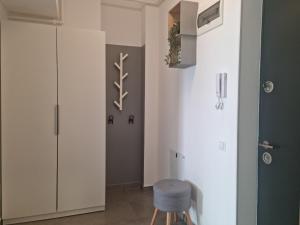 a bathroom with a white cabinet and a blue stool at Studio Nova - Minimalist and Elegant with Parking in Bucharest
