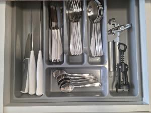 a drawer filled with utensils in a kitchen at Studio Nova - Minimalist and Elegant with Parking in Bucharest