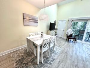 a dining room with a white table and chairs at Birdies Rest in Little River