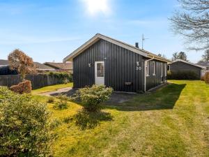 a black house with a yard at Holiday Home Bara - from the sea by Interhome in Hadsund