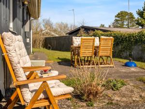 three chairs and a table in a yard at Holiday Home Bara - from the sea by Interhome in Hadsund