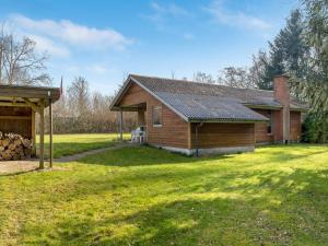 a house with a grass yard in front of it at Holiday Home Franzisca - 200m to the fjord by Interhome in Roslev