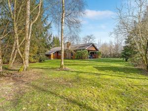 a house in the middle of a field with trees at Holiday Home Franzisca - 200m to the fjord by Interhome in Roslev