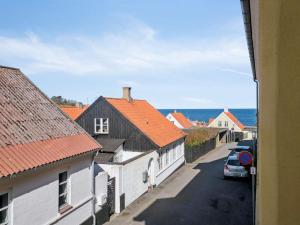 a view of a street in a town with houses at Apartment Merta - 500m from the sea by Interhome in Gudhjem +19 photos