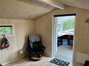 a room with a chair in the corner of a room at Holiday Home Seba - 1km to the fjord by Interhome in Hemmet