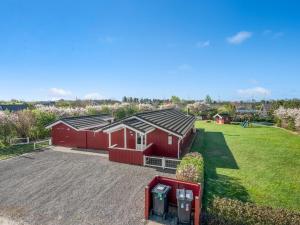 an aerial view of a red barn with two parking meters at Holiday Home Seba - 1km to the fjord by Interhome in Hemmet
