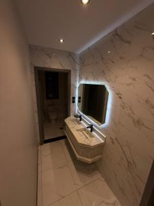 a marble bathroom with a sink and a mirror at Summo bilding in Jeddah +43 photos