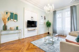 a living room with a couch and a table at Suite Deluxe royauté Jacuzzi, Mulhouse Centre in Mulhouse