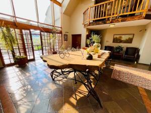 a large room with a wooden table in it at Pretoria Mansion Boutique Hotel Coral Tree in Pretoria