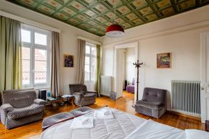una camera da letto con un letto e due sedie e un soffitto di FLI I n' II Family Listed Inn since 1850 a Nauplia