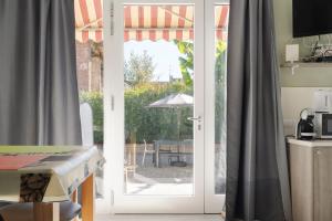 an open door to a patio with a table at Residence Campagnole in Vicolungo