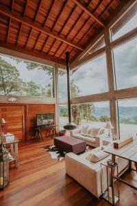 a living room with a couch and a fireplace at Chalet nas Nuvens with Infinity Pool in São Bento do Sapucaí