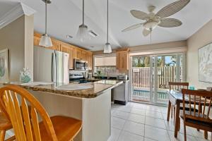 a kitchen with a large island with a counter top at Ocean72 Holmes Beach Vacation Home with Private Pool & hot tub & Walk-to-Beach Access in Holmes Beach
