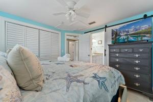 a bedroom with a bed and a dresser at Ocean72 Holmes Beach Vacation Home with Private Pool & hot tub & Walk-to-Beach Access in Holmes Beach +46 photos