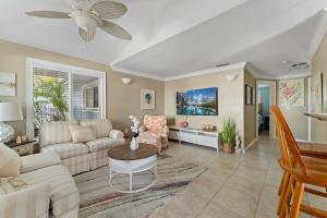 a living room with a couch and a table at Ocean72 Holmes Beach Vacation Home with Private Pool & hot tub & Walk-to-Beach Access in Holmes Beach