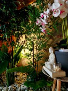 a statue sitting on a table next to a plant at Le Cruzillou in Saint-Jean-Soleymieux +6 photos