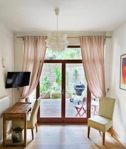 a living room with a table and a sliding glass door at Ferienwohnung Villa 16F in Pirna