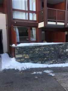 a building with snow on the side of it at Ski en 5 secondes! in Val Cenis +2 photos