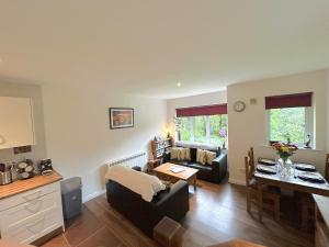 a living room with a couch and a table at 93 Clifden Glen family friendly cottage in Clifden +12 photos