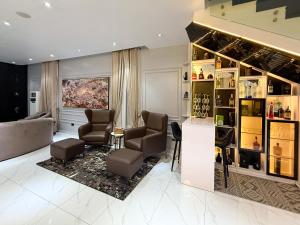 a living room with a couch and chairs and a salon at Ncomhome Luxury Villa in Lekki