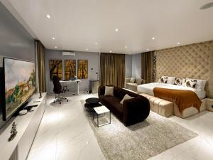 a large bedroom with a bed and a couch at Ncomhome Luxury Villa in Lekki