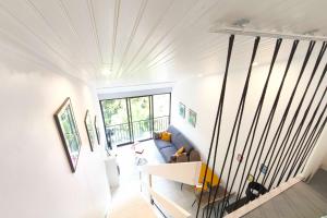 a living room with a blue couch and a window at Studio with sea view in Orcino